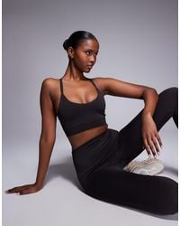 4505 - Seamless Multi Strap Medium Support Sports Bra With Removable Padding - Lyst