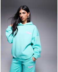 Kaiia - Hoodie oversize d'ensemble avec logo imprimé en relief - turquoise et rose pastel - Lyst