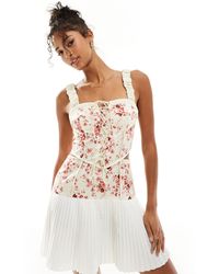 ASOS - Vestido corto con estampado floral rosa, cuerpo corsetero, cordones y falda plisada - Lyst