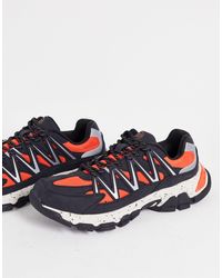 Bershka - Sneakers da corsa riflettenti con suola spessa, colore nero e arancione - Lyst