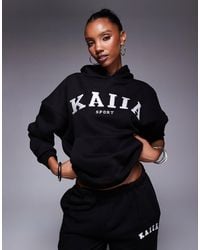 Kaiia - Sweat à capuche d'ensemble oversize sport en coton mélangé avec logo brodé - et crème - Lyst