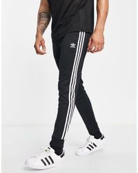 adidas Originals - Adicolor - joggers skinny neri con 3 strisce - black - Lyst