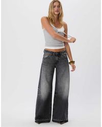 Stradivarius - – d66 – jeans mit niedrigem bund, sehr weitem bein und schwarzer denim-waschung - Lyst