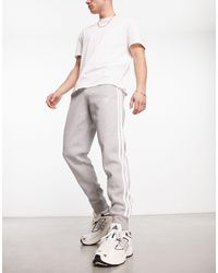 adidas Originals - Joggers gris pálido con diseño - Lyst