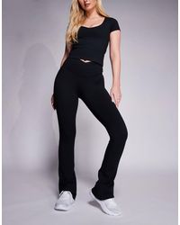4505 - Hourglass Icon Wrap Waist Slim Kick Yoga legging - Lyst