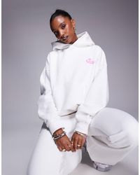 Kaiia - Sweat à capuche d'ensemble en coton majoritaire avec logo étoile au dos - blanc et rose - Lyst