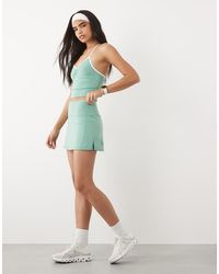 4505 - Active Tennis Skirt With Under Short And Phone Pocket - Lyst