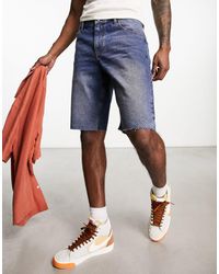 ASOS - Short en jean slim coupe classique avec ourlet brut - moyen délavé - Lyst