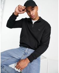 Calvin Klein - Sudadera negra cómoda con media cremallera y logo - Lyst