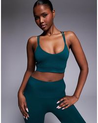 4505 - Seamless Multi Strap Medium Support Sports Bra With Removable Padding - Lyst