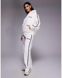 Kaiia - Cotton Rich Embroidered Logo Side Stripe Wide Leg Sweatpants - Lyst