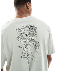 ASOS - Camiseta holgada con estampado floral delineado en la espalda - Lyst