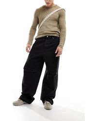 Weekday - Astro - jeans larghi a fondo ampio neri con strappo sul ginocchio e dettagli invecchiati - Lyst