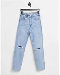 Stradivarius – Schmal geschnittene Mom-Jeans aus Bio-Baumwolle mit Stretch und Rissen - Blau