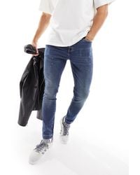 ASOS - Jeans skinny lavaggio medio con dettagli effetto vernice - Lyst
