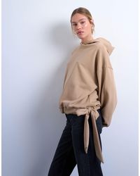 TOPSHOP - Sweat à capuche à coutures apparentes et ourlet à nouer - fauve - Lyst