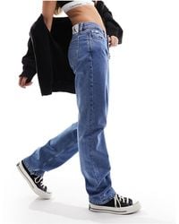 Calvin Klein - Jeans dritti a vita bassa lavaggio medio - Lyst