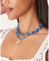 ASOS - Collar De Varias Hileras Con Fragmentos Azules De Piedra Sintética Y Colgante De Flor Dorada De - Lyst