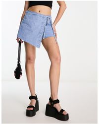 Bershka - Mini-jupe portefeuille en jean à ourlet brut - clair - Lyst