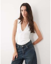 GOOD AMERICAN - Vormgevende Mouwloze Body Van Katoen Met Diepe V-Hals - Lyst