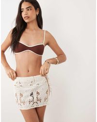 Missy Empire - Cotton Semi Sheer Lace Tie Side Detail Mini Skirt - Lyst