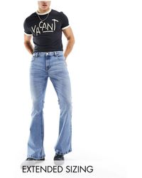 ASOS - Jeans a zampa elasticizzato lavaggio chiaro - Lyst