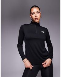The North Face - Camiseta Negra Con Cremallera Corta Y Logo Flex De Training - Lyst