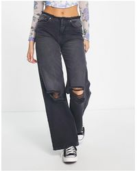 ONLY - Jeans a fondo ampio con vita bassa sfrangiata neri - Lyst
