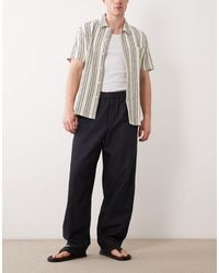 SELECTED - Pantalon ample en lin mélangé - indigo délavé - Lyst