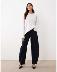 ARRANGE - Tova Barrel Tapered Curved Leg Jean With Roll Hem - Lyst