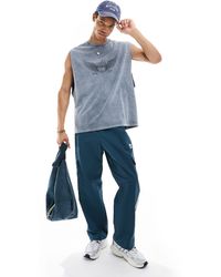 ASOS - Camiseta azul lavado extragrande sin mangas con estampado estilo grunge en el pecho - Lyst