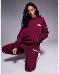 Kaiia - Sweat à capuche d'ensemble oversize en coton majoritaire avec logo brodé - bordeaux et rose - Lyst