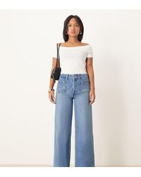 ASOS - Asos Design Petite High Rise Wide Leg Jeans With Front Pockets In Mid - Lyst