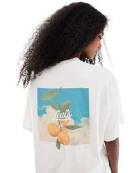 Levi's - T-Shirt Oversize Bianca Con Stampa Di Arance Sul Retro - Lyst