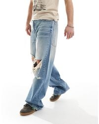 Bershka - Washed Distressed Denim baggy Jeans - Lyst