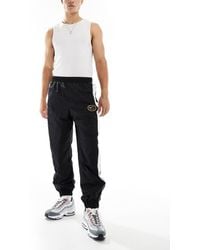Nike - Swoosh Air Woven joggers - Lyst