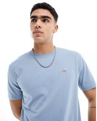 Hollister - Camiseta azul holgada con logo bordado - Lyst