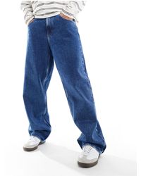 Tommy Hilfiger - Aiden - jeans larghi lavaggio medio - Lyst