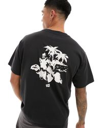 Levi's - T-shirt nera con stampa di palme e del logo al centro e sul retro - Lyst