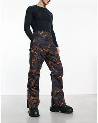 Threadbare - Pantaloni da sci neri e arancioni con stampa - Lyst