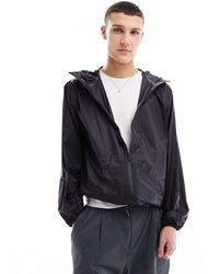 Rains - Norton - giacca ultra leggera idrorepellente nera con cappuccio - Lyst