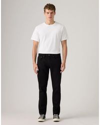 Levi's - Vaqueros Negros De Corte Tapered 502 De - Lyst