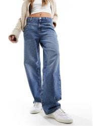 Mango - Jeans ampi a vita medio alta medio con strappi - Lyst
