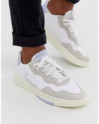 adidas Originals – SC Premier – e Sneaker mit blauer Ferse - Weiß