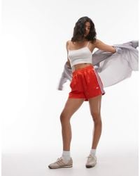 adidas Originals - Sprinter - short en satin à logo trois bandes - Lyst
