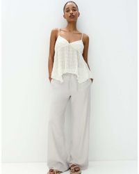 Pull&Bear - Broek Met Wijde Pijpen, Gestrikte Taille En Gerafelde Zoom - Lyst