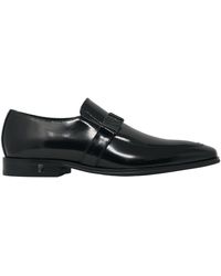 Versace Zapatos negros de cuero con logo de hebilla de