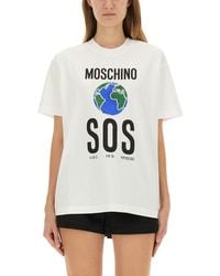 Moschino - Relaxed-Fit Cotton T-Shirt With Bold Globe Print - Lyst