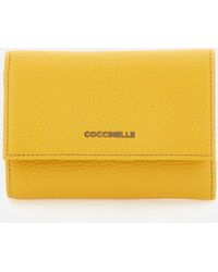 Coccinelle - Ocra Morbida Metallica Nel Portafoglio Giallo - Lyst