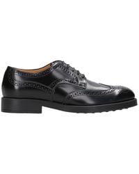Tod's - Platte Schoenen Zwart - Lyst